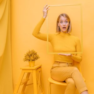woman-holding-frame-around-face-yellow-scene_23-2148184979 Branding Frame