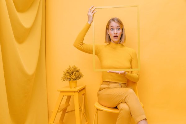woman-holding-frame-around-face-yellow-scene_23-2148184979 Branding Frame